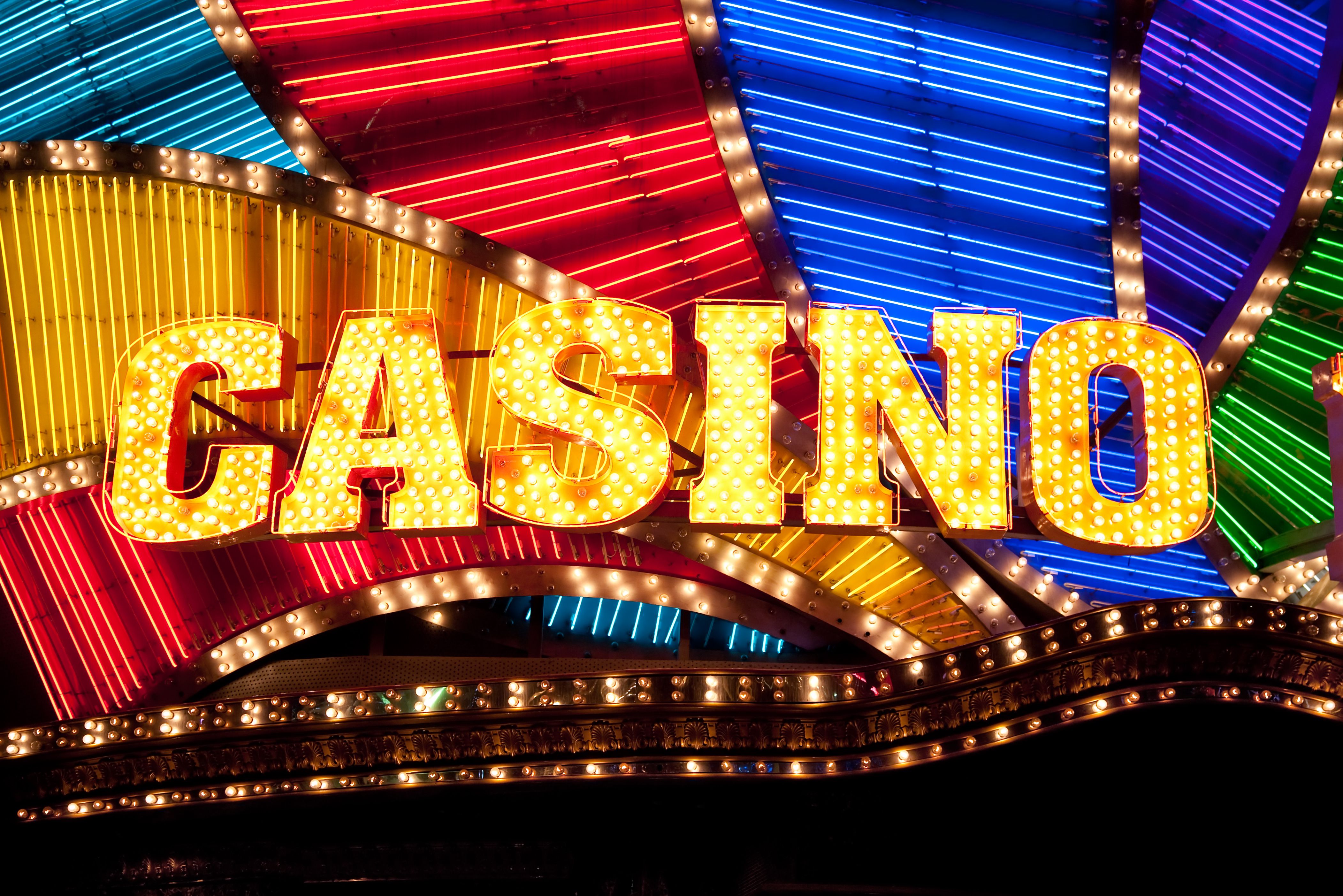 A graphic illustrating the difference between a casino bonus and an in-game slot bonus feature.